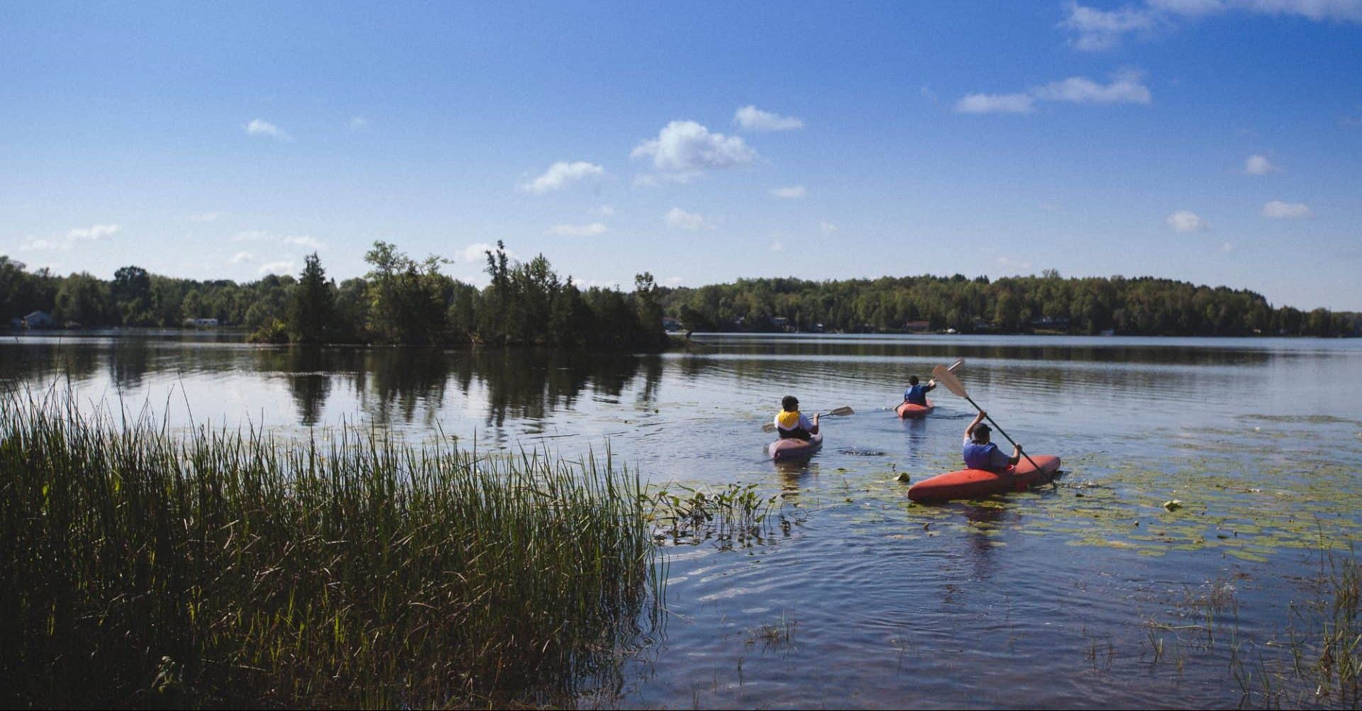 kids Kayaking on the lake at circle square ranch summer camp e1527521007392